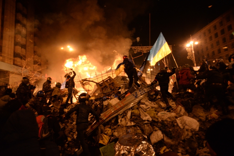 photo credit - Mstyslav Chernov -https://commons.wikimedia.org/wiki/File:SState_flag_of_Ukraine_carried_by_a_protester_to_the_heart_of_developing_clashes_in_Kyiv,_Ukraine._Events_of_February_18,_2014.jpg